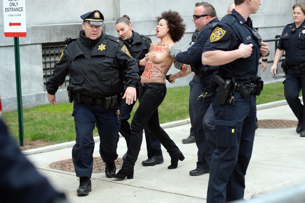 Police taking away a protestor – topless Nicole Rochelle pictures gallery, pic 2