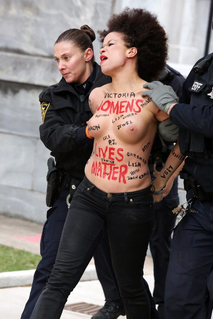 Police taking away a protestor – topless Nicole Rochelle pictures gallery, pic 4