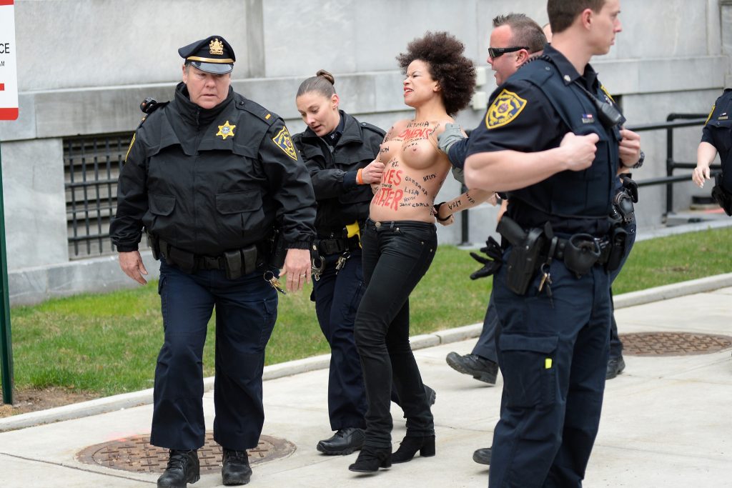 Police taking away a protestor – topless Nicole Rochelle pictures gallery, pic 8