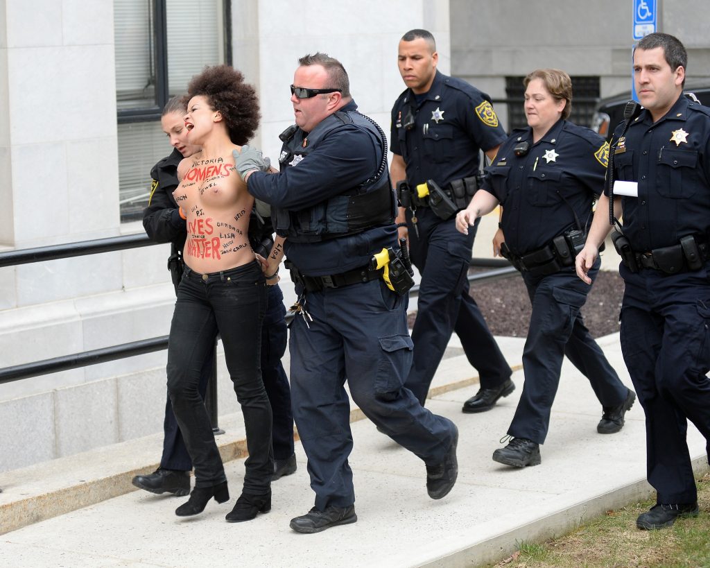 Police taking away a protestor – topless Nicole Rochelle pictures gallery, pic 12