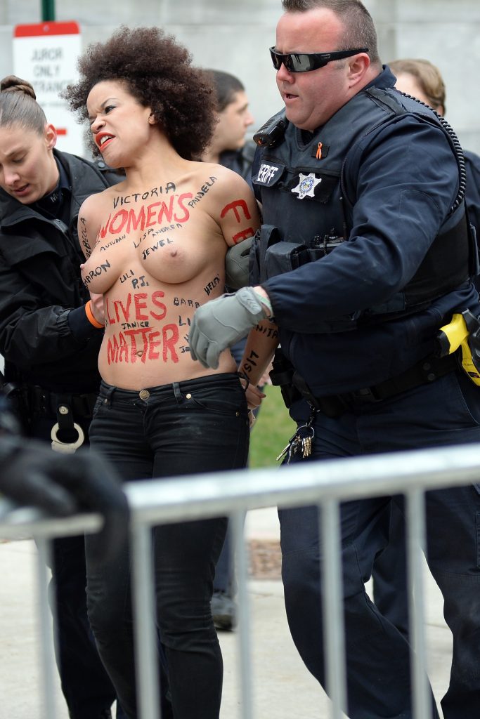 Police taking away a protestor – topless Nicole Rochelle pictures gallery, pic 14