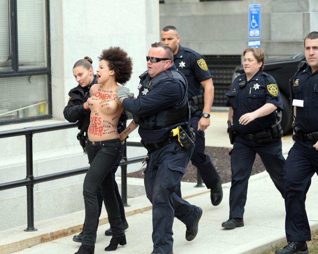 Police taking away a protestor – topless Nicole Rochelle pictures gallery, pic 18