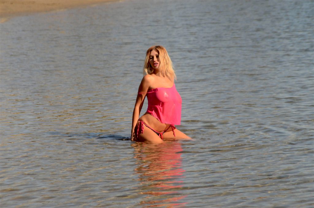 Nadeea Volianova wearing an eye-catching see-through top on the beach gallery, pic 18