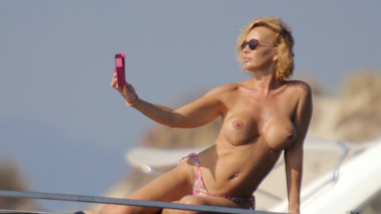 Topless Marlene Mourreau snapping a bunch of sexy selfies on a yacht