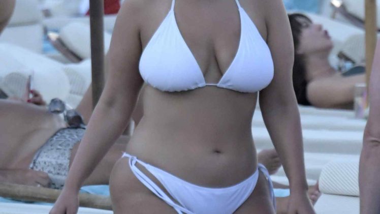Ashley Graham soaking up the sun in a revealing white bikini