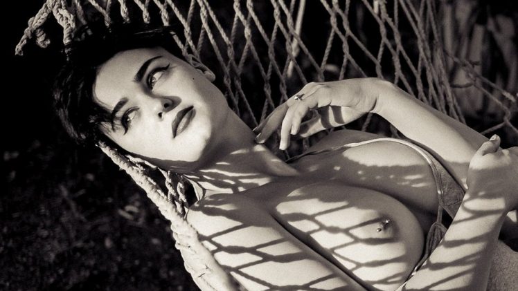 Busty brunette Stefania Ferrario resting topless in a hammock
