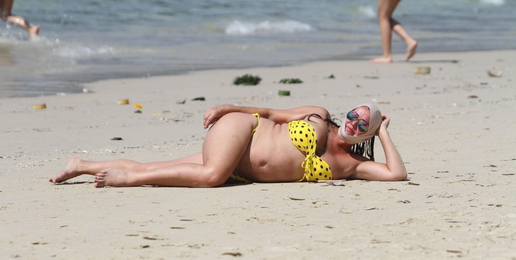 Ugly, fat, and old bitch named Lisa Appleton rolls around in the sand gallery, pic 32