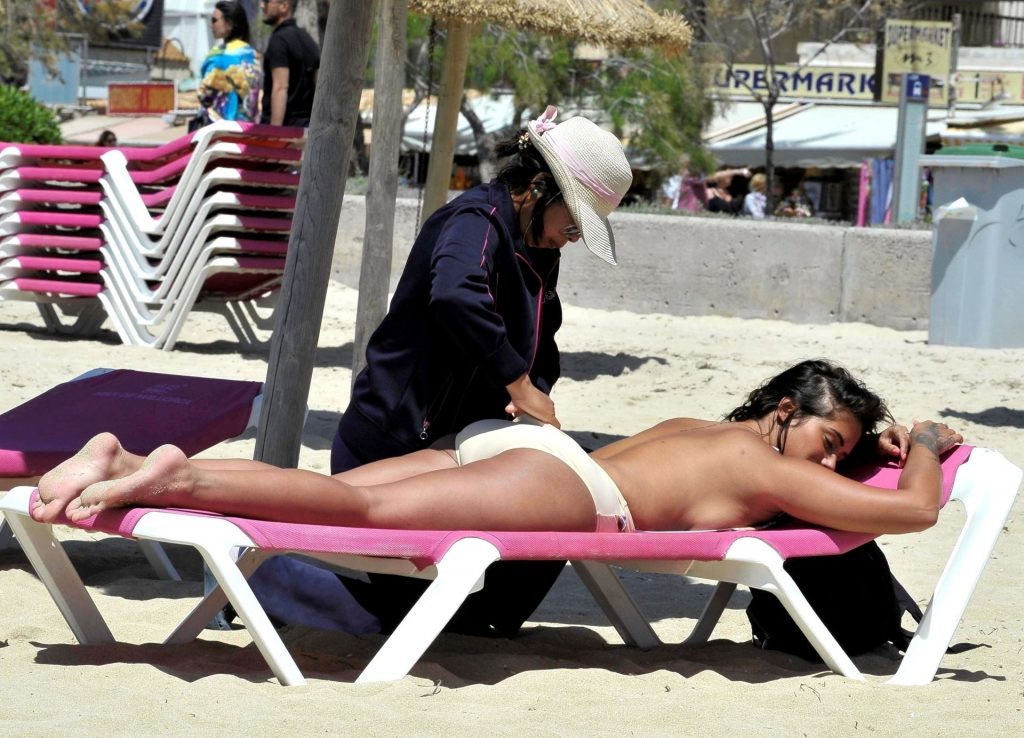 Topless Diva Malin Andersson Enjoying a Quick Backrub at the Beach gallery, pic 40