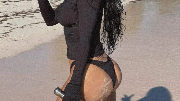 Trendsetter Kim Kardashian Showing Her Ample Cleavage on a Beach